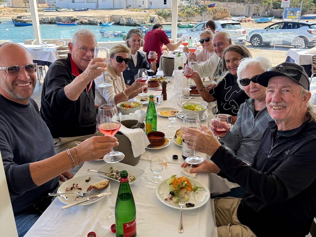 Tour guests enjoying a delicious Italian meal on the water. 