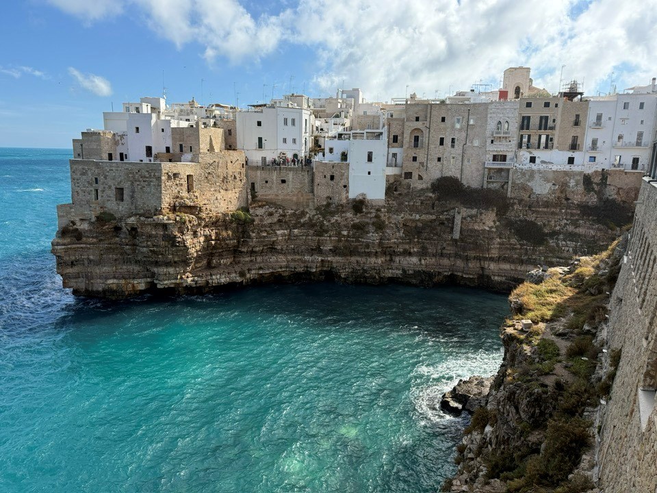 Puglia coastline with historic housing lining the cliffs. 