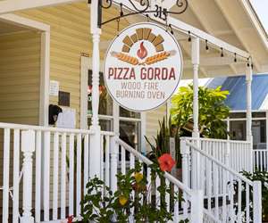 Exterior porch and signage at Pizza Gorda. 